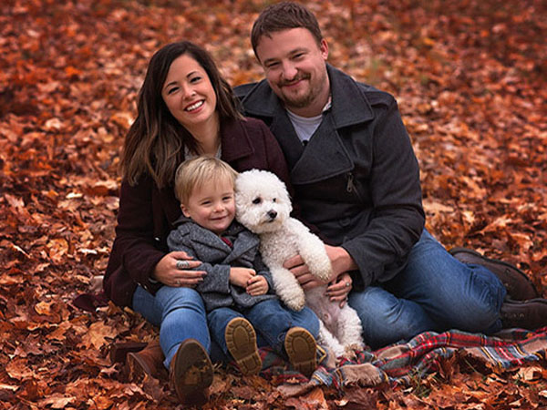 image of family with their child and fluffy dog